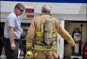 Captain Edward Dew and Fire Engineer Jerry Ayscue prepare hose lines during a training exercise.