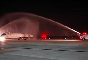 Fire Rescue provides a ceremonial water arch for an aircraft returning a fallen soldier home.