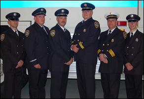Fire Engineer Jason Philyaw, Lt. Cpt. Brian Phillips, Fire Engineer Robert O’Shields, Cpt. Doug Carter, Deputy Chief Joe Van Roy and Fire Engineer Will Patterson stand in dress uniforms.