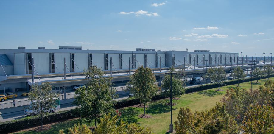 Exterior of Terminal 1 at RDU with trees in the foreground.