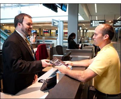 Guest talking to attendant at Special Events Desk in RDU Terminal 2
