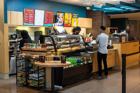 A customer ordering at the counter at Beyu Caffe in Terminal 2
